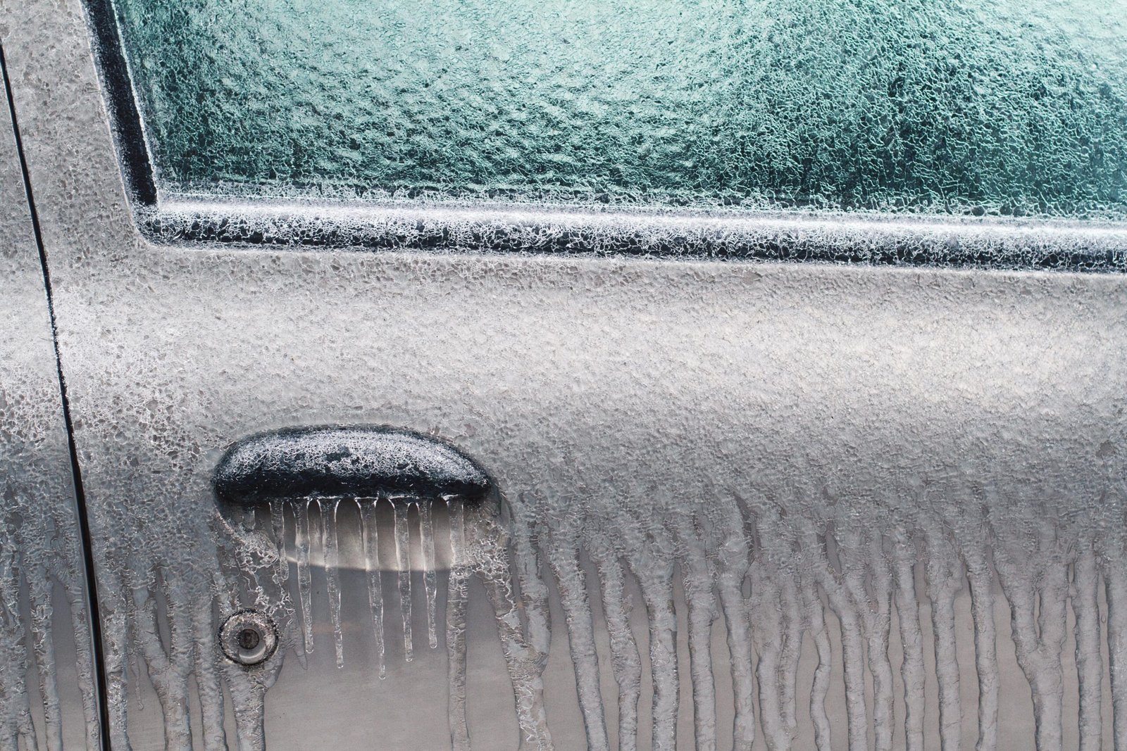 closeup-of-silver-car-door-lock-covered-in-ice-and-2023-11-27-05-20-21-utc-min-scaled.jpg